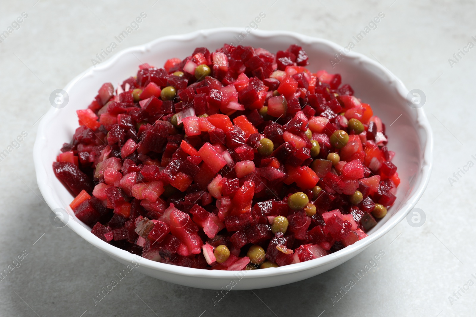 Photo of Delicious fresh vinaigrette salad on light grey table