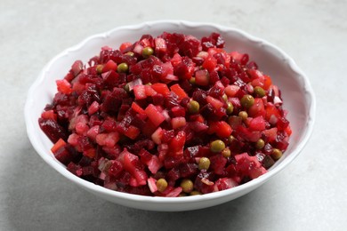 Delicious fresh vinaigrette salad on light grey table