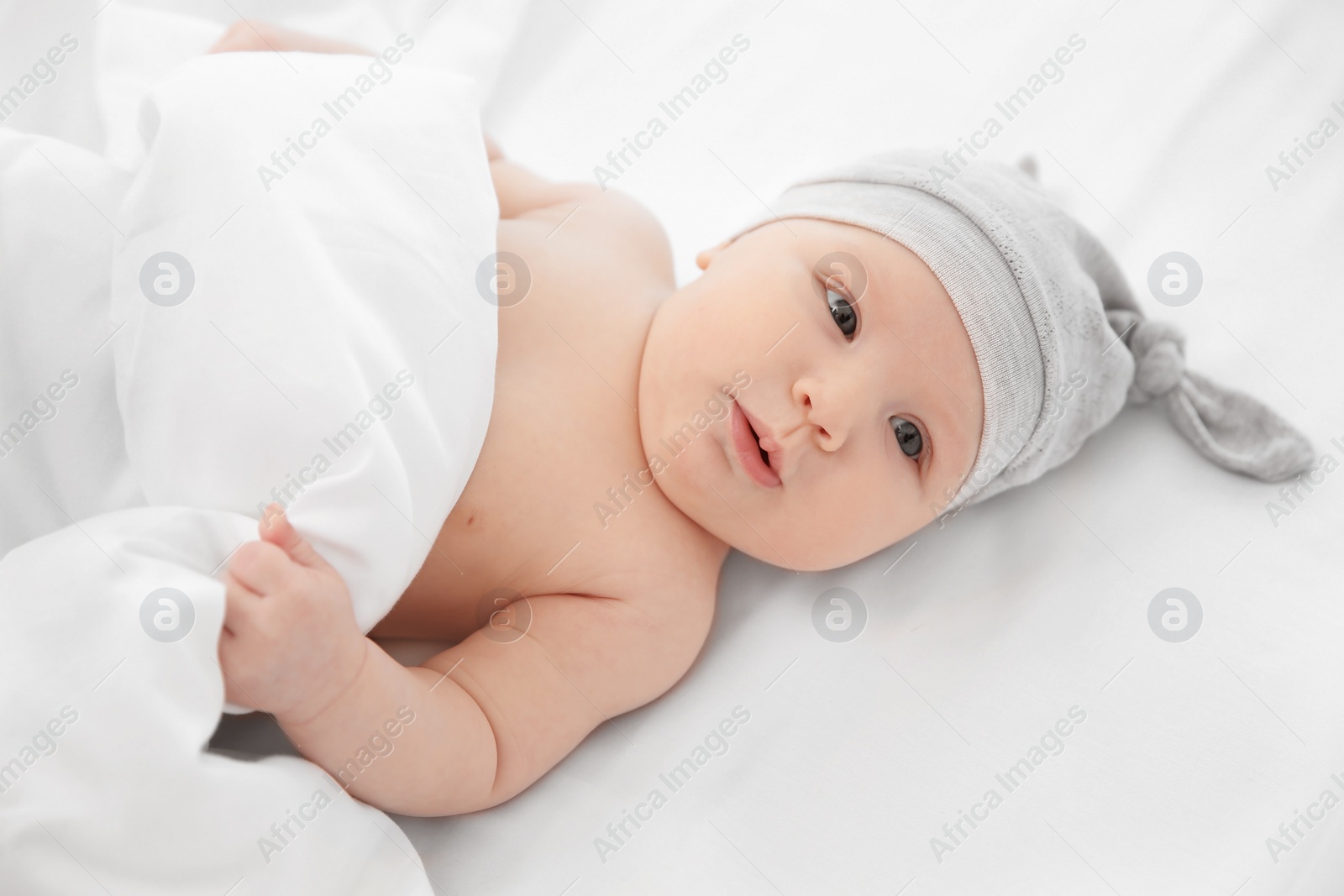 Photo of Adorable baby girl lying in bed