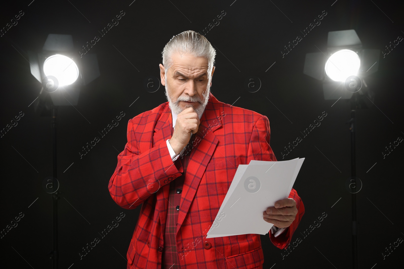 Photo of Senior actor with script performing on stage