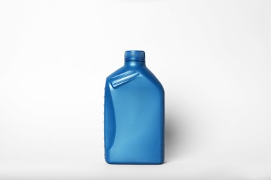 Photo of Motor oil in blue canister on light background