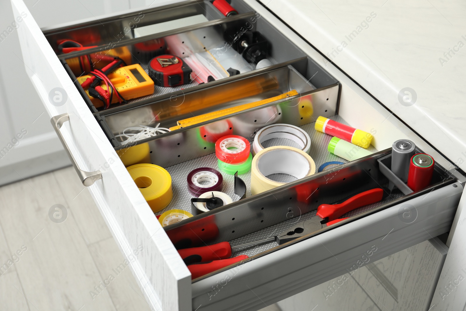 Photo of Set of instruments in open desk drawer indoors