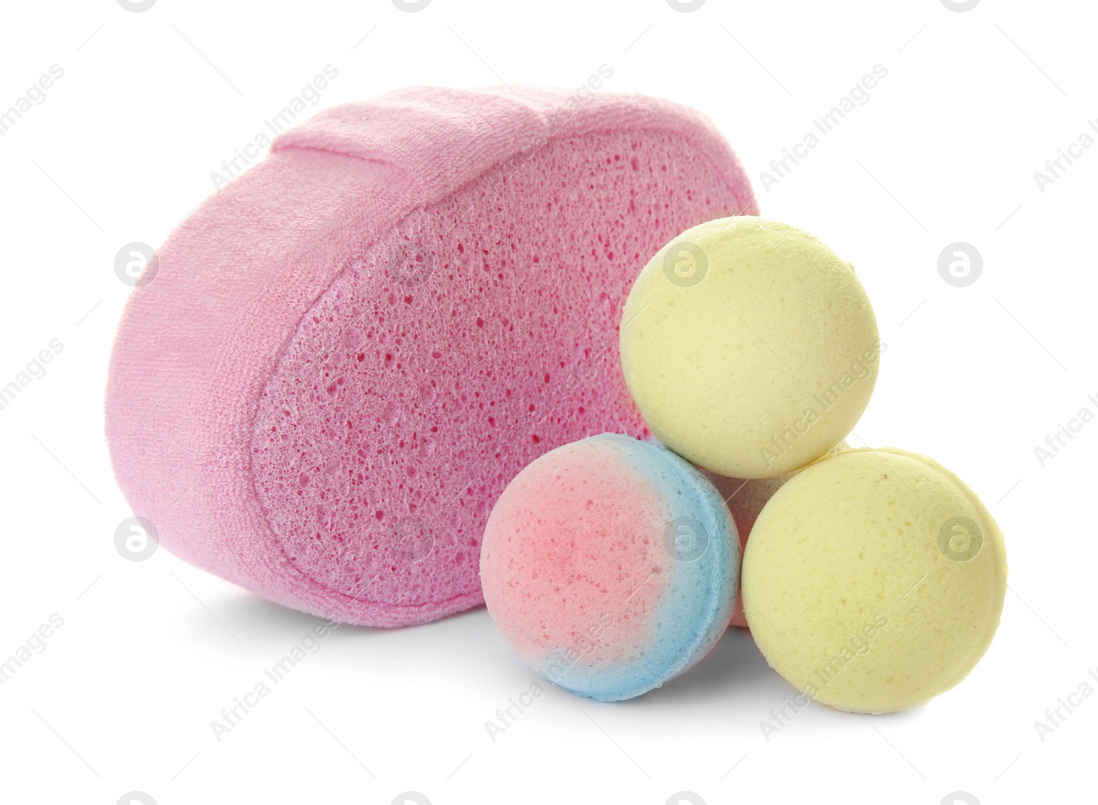 Photo of Pink sponge and bath bombs on white background