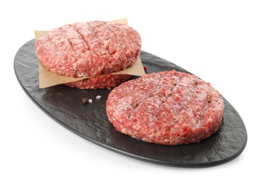 Photo of Raw hamburger patties with spices on white background