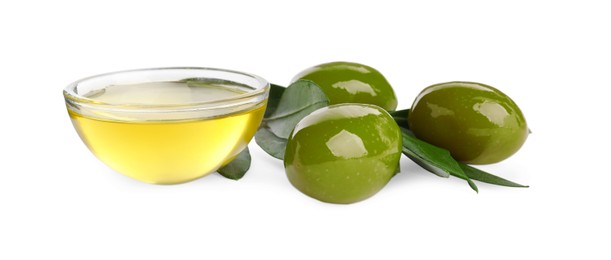 Cooking oil in glass bowl, olives and leaves on white background