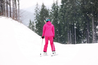Skier on slope at resort. Winter vacation