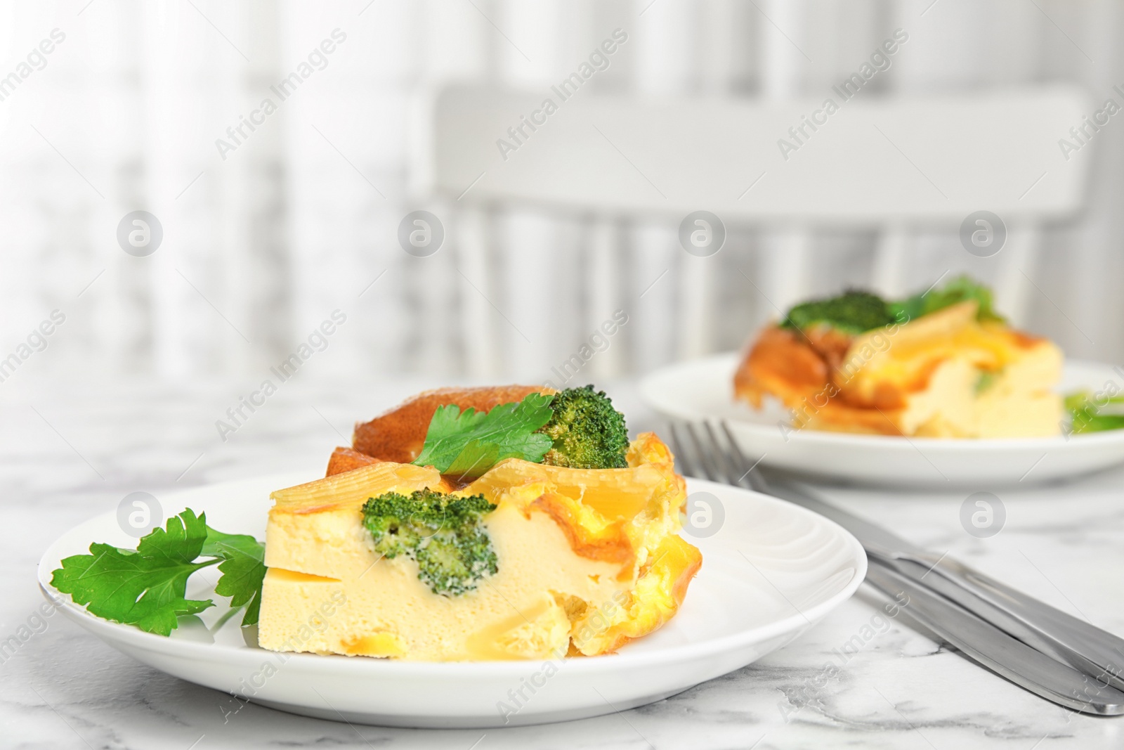 Photo of Tasty broccoli casserole served on white marble table indoors. Space for text