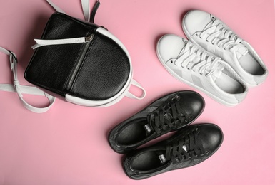 Flat lay composition with stylish shoes on color background