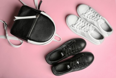 Photo of Flat lay composition with stylish shoes on color background