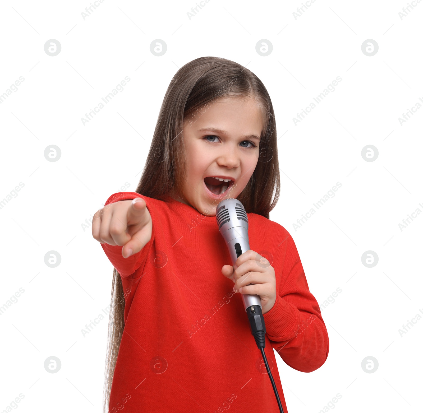 Photo of Cute little girl with microphone singing on white background