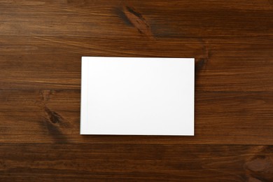 Blank paper brochure on wooden table, top view. Mockup for design