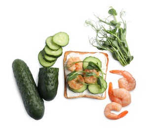 Photo of Tasty toast with cream cheese, shrimps, cucumbers and microgreens on white background, top view