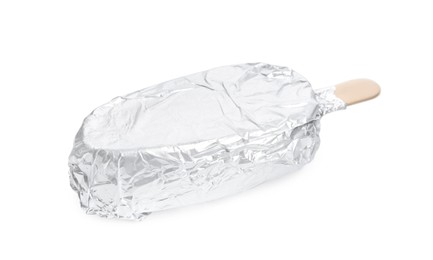 Photo of Ice cream bar wrapped in foil on white background