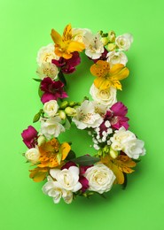 Photo of Number 8 made of beautiful flowers on green background, flat lay. International Women's day