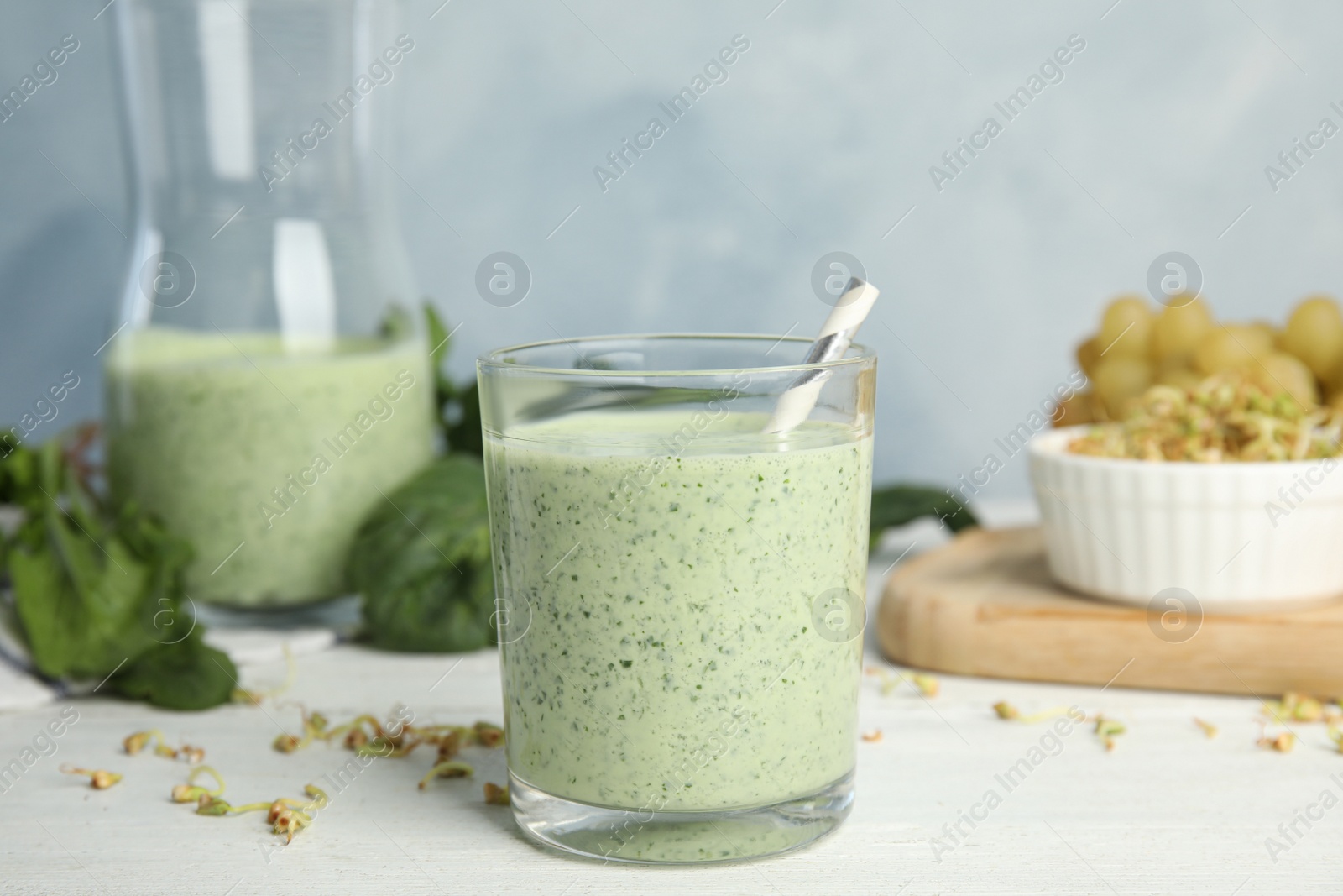 Photo of Green buckwheat smoothie on white wooden table