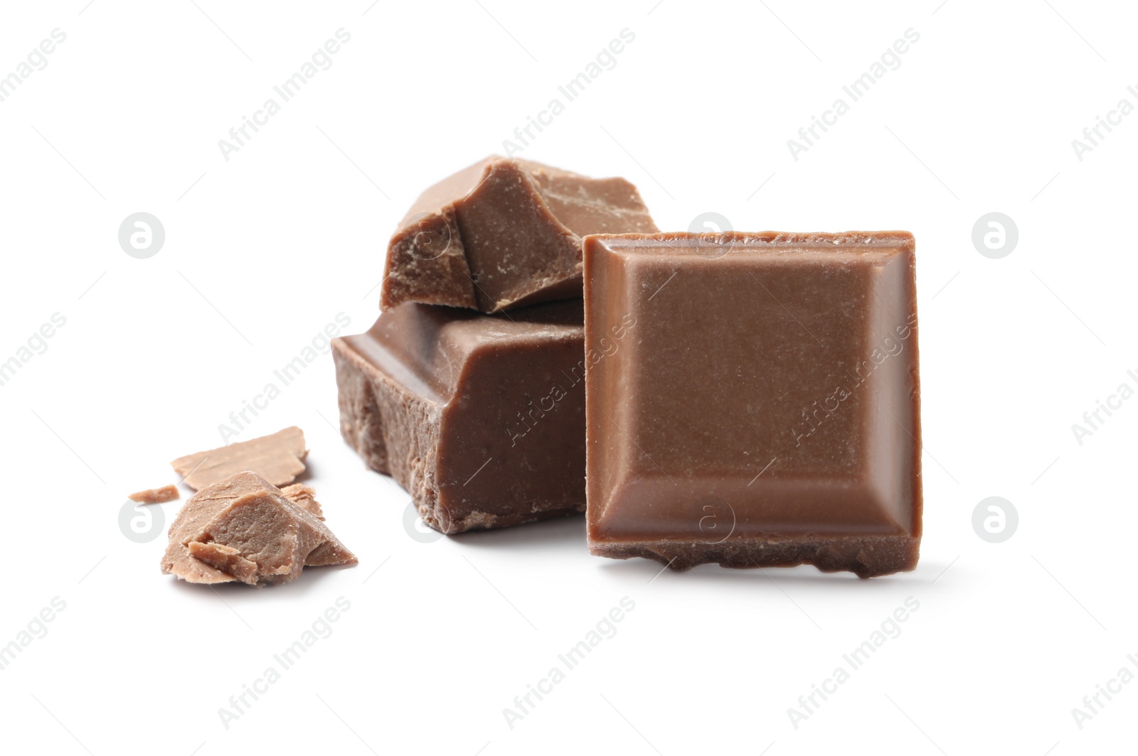 Photo of Pieces of delicious milk chocolate isolated on white