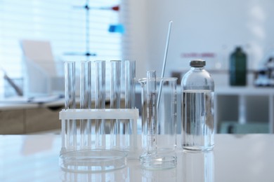 Photo of Laboratory analysis. Different glassware on white table indoors