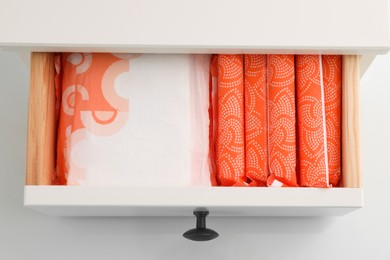 Photo of Storage of different feminine hygiene products in drawer, top view