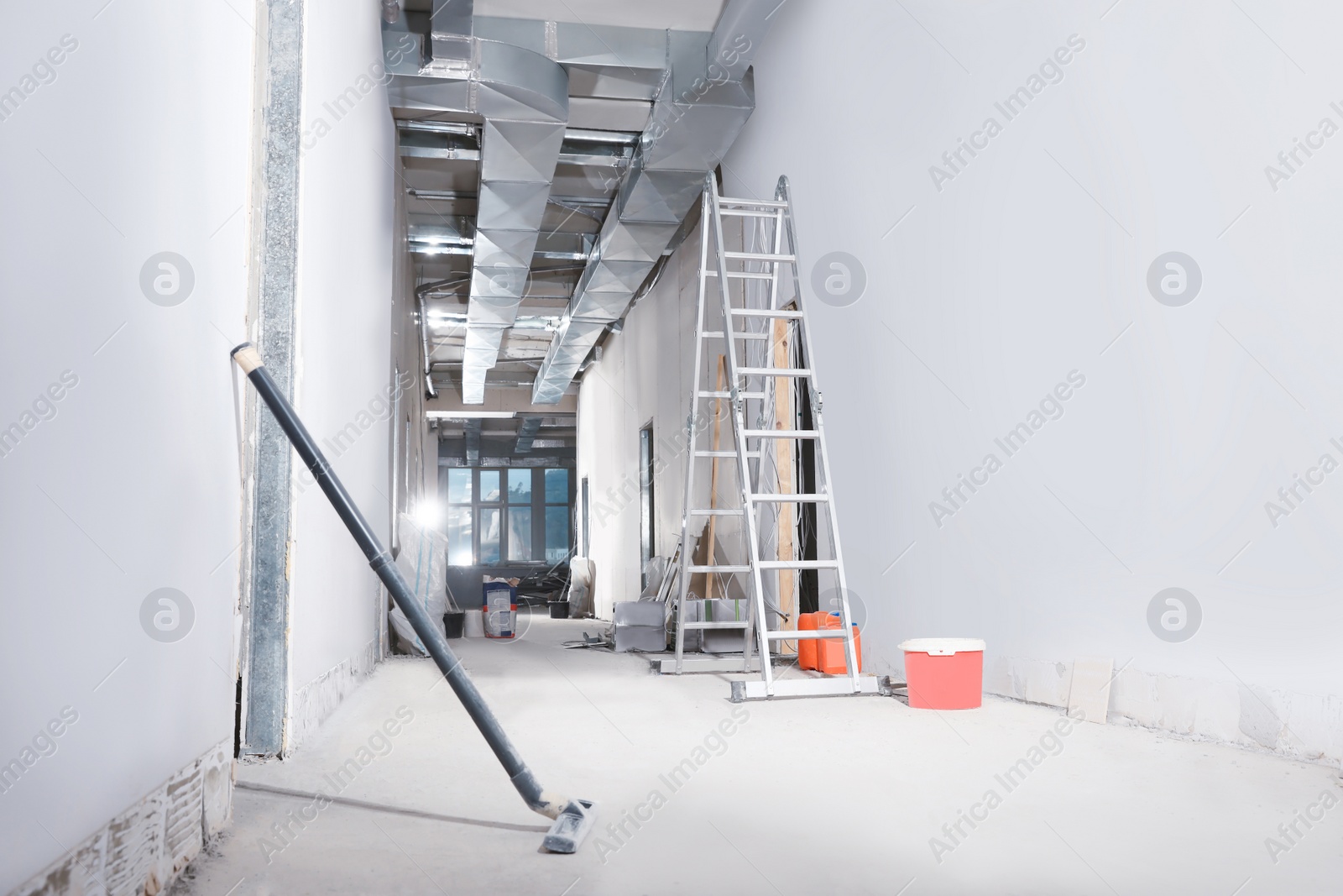 Photo of Metal ladder and building materials in hall prepared for renovation