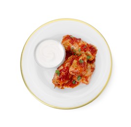 Photo of Plate of delicious stuffed cabbage rolls with sour cream isolated on white, top view