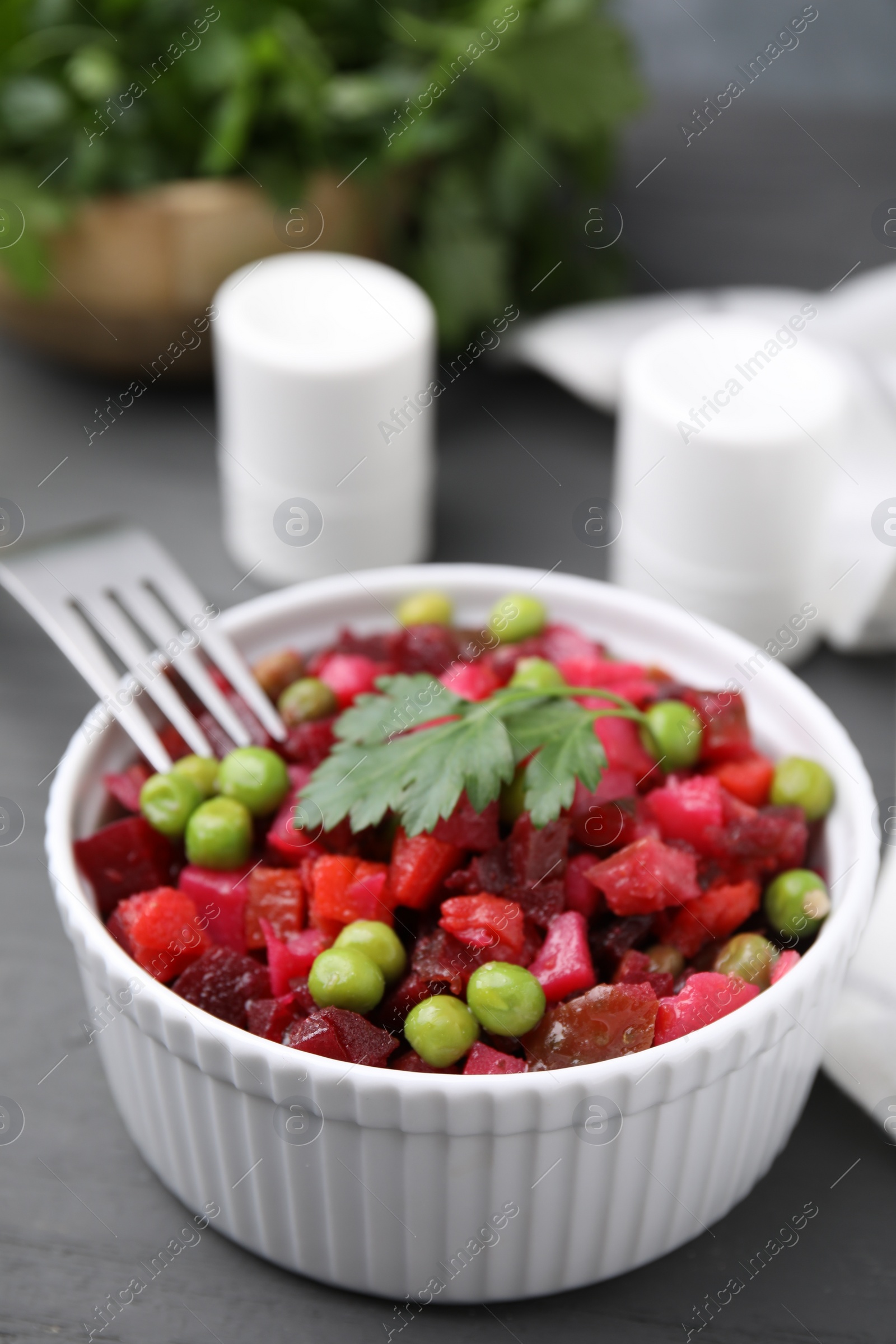 Photo of Delicious vinaigrette salad on grey table, closeup