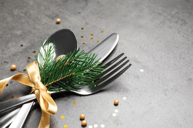 Photo of Cutlery set for festive table on grey background, closeup