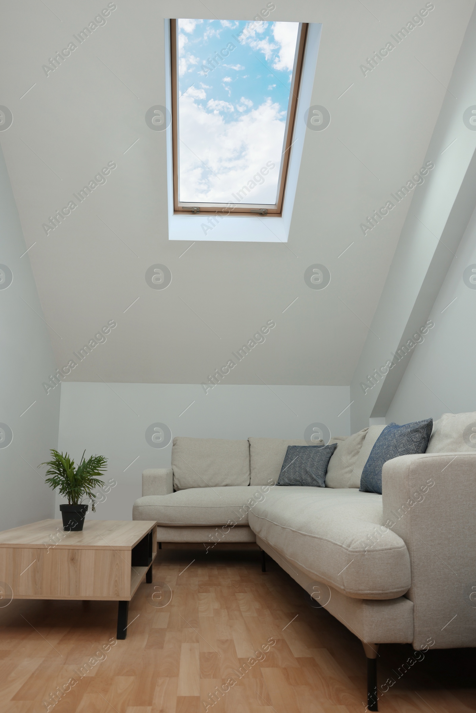 Photo of Attic room interior with slanted ceiling and furniture