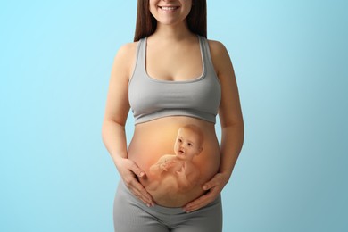 Image of Pregnant woman and baby on light blue background, closeup view of belly. Double exposure
