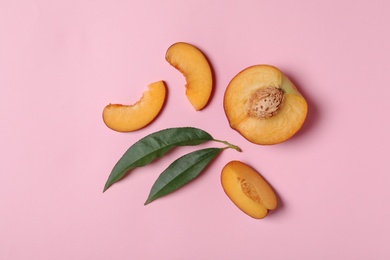 Photo of Flat lay composition with sweet juicy peach on pink background