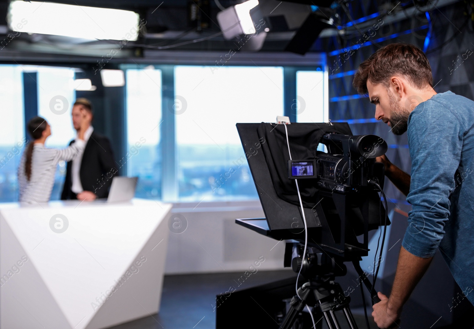 Photo of Professional video camera operator working in studio. News broadcasting