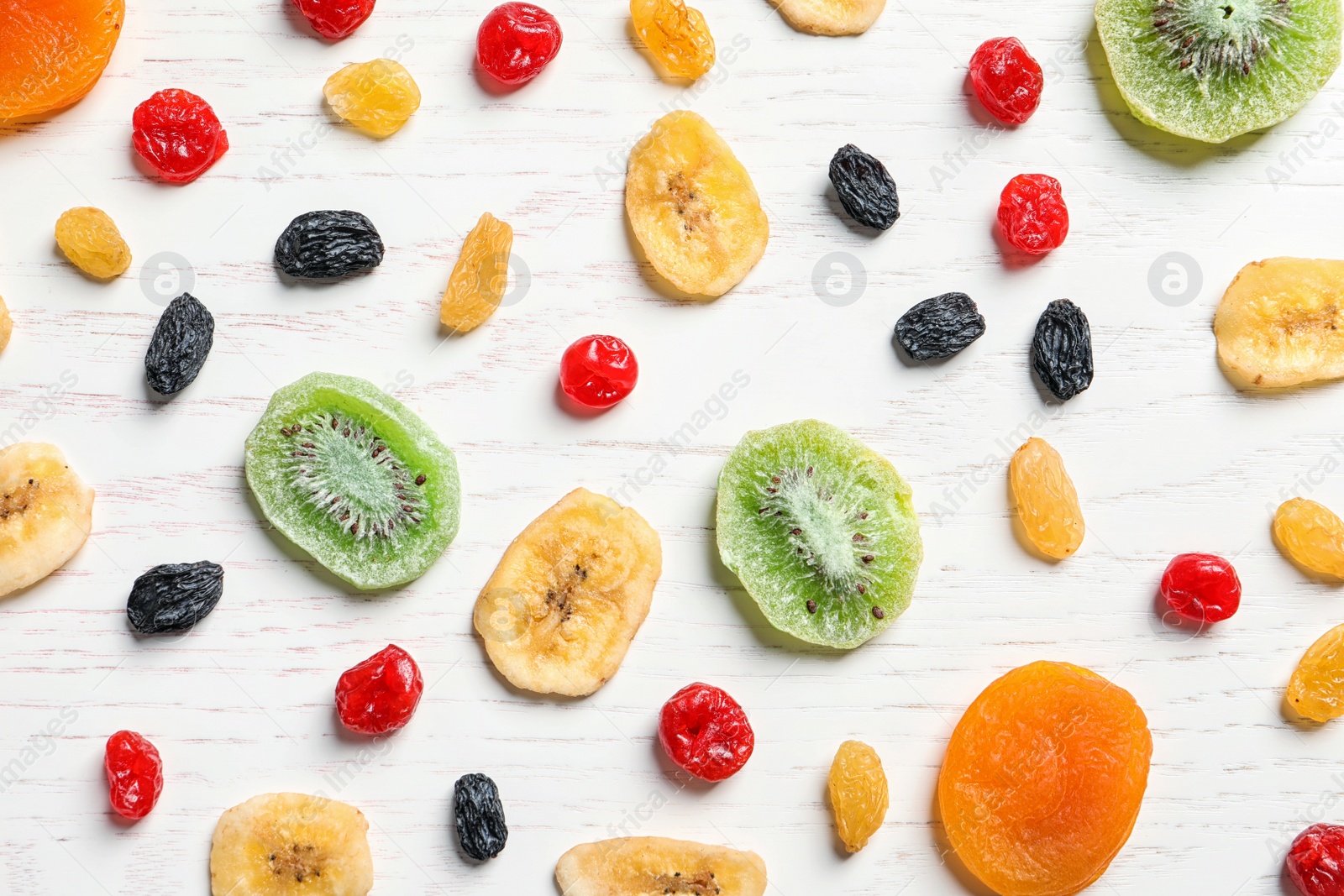 Photo of Flat lay composition with different dried fruits on wooden background. Healthy lifestyle