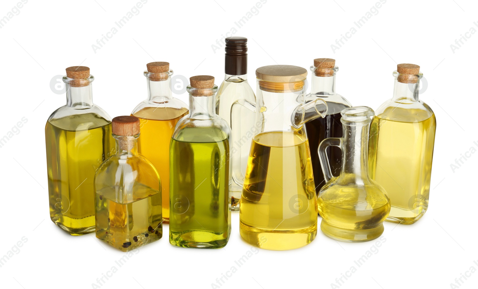 Photo of Vegetable fats. Glassware of different cooking oils isolated on white