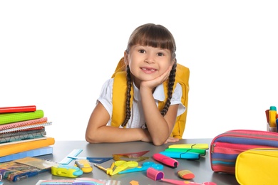 Photo of Schoolgirl at table with stationery against white background