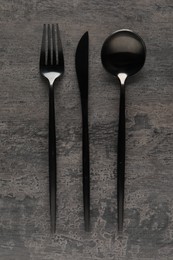 Stylish cutlery on grey table, flat lay