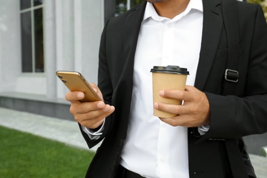 Photo of Man with smartphone on city street, closeup