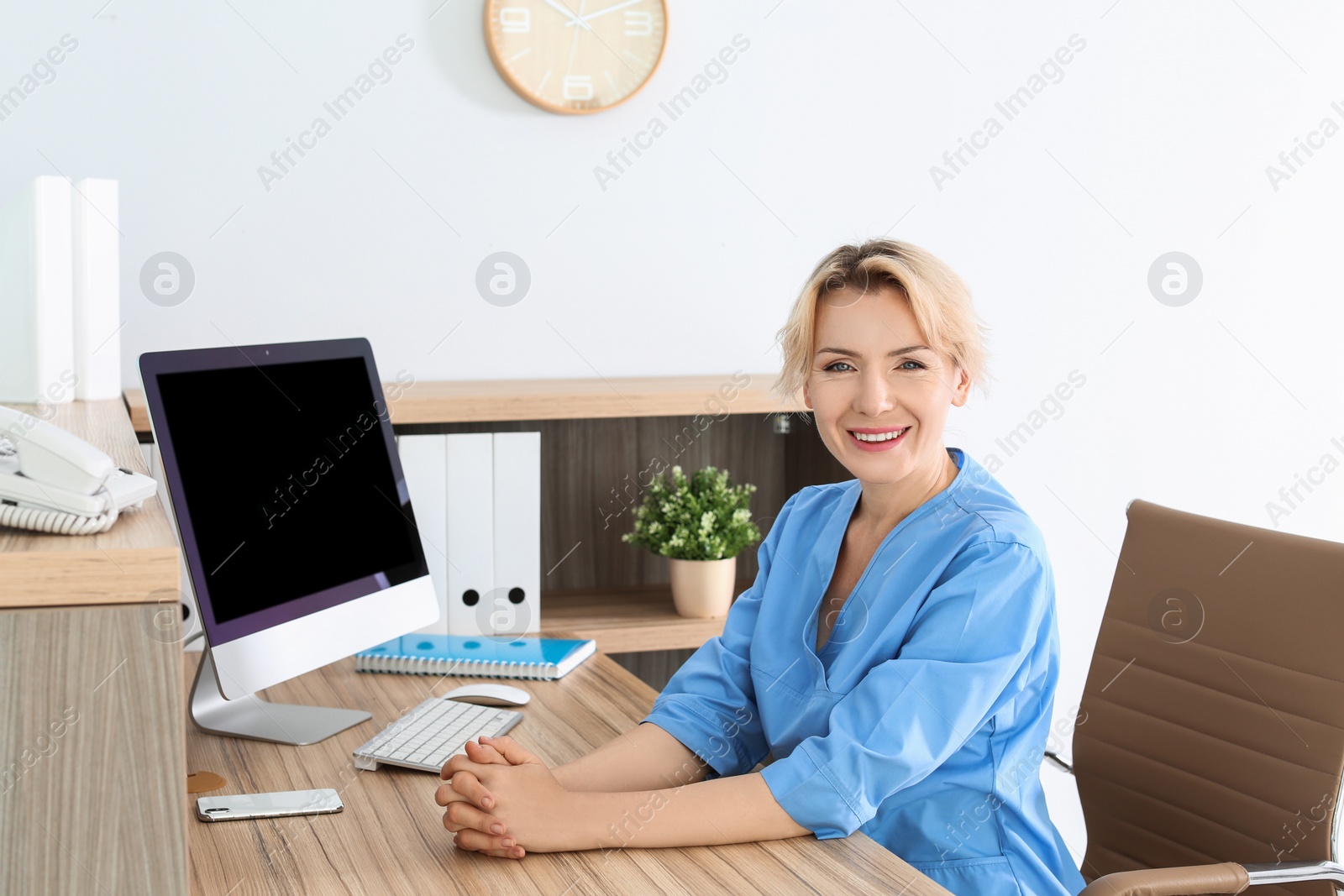 Photo of Female medical assistant at workplace in clinic. Health care service