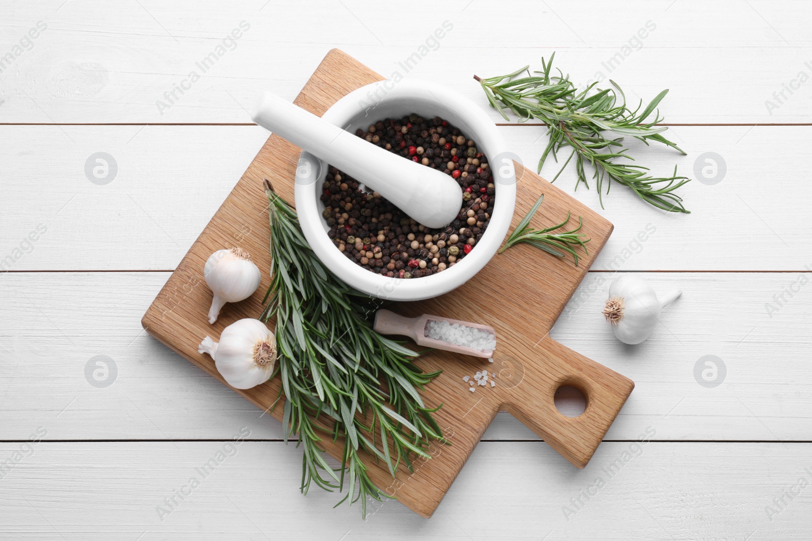 Photo of Flat lay composition with fresh green rosemary and mortar on white wooden table