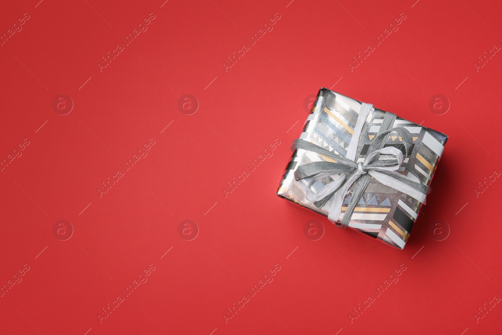 Photo of Beautiful gift box on color background, top view with space for text