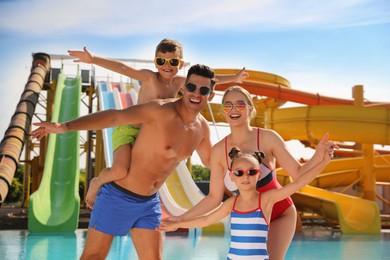 Photo of Happy family near pool in water park