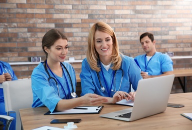 Medical students in uniforms studying at university