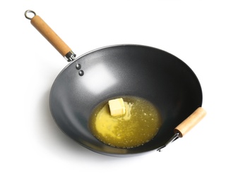 Photo of Frying pan with melting butter on white background