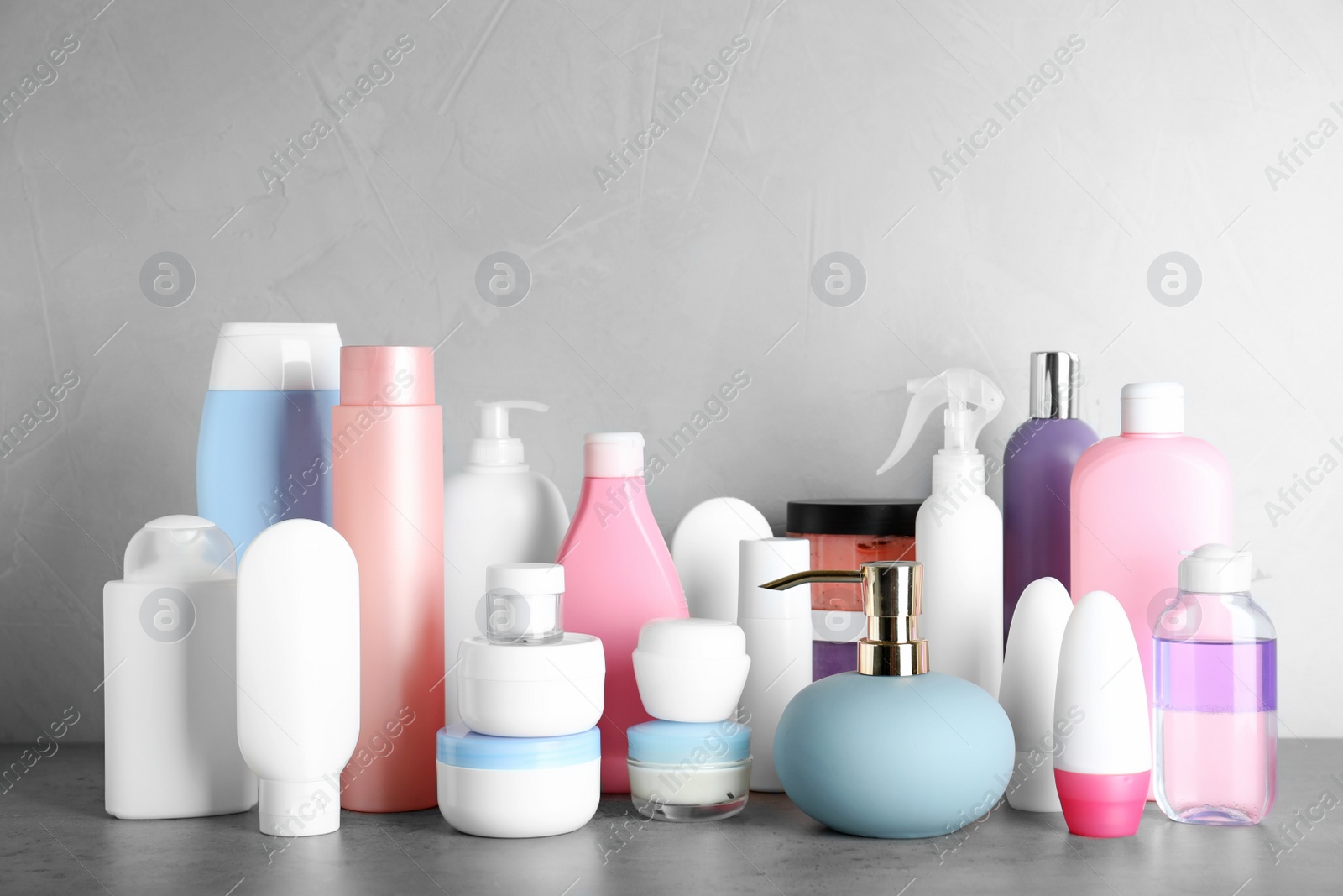 Photo of Different body care products on table against grey background