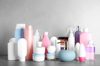 Photo of Different body care products on table against grey background