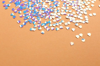 Photo of Shiny bright light blue glitter on beige background. Space for text