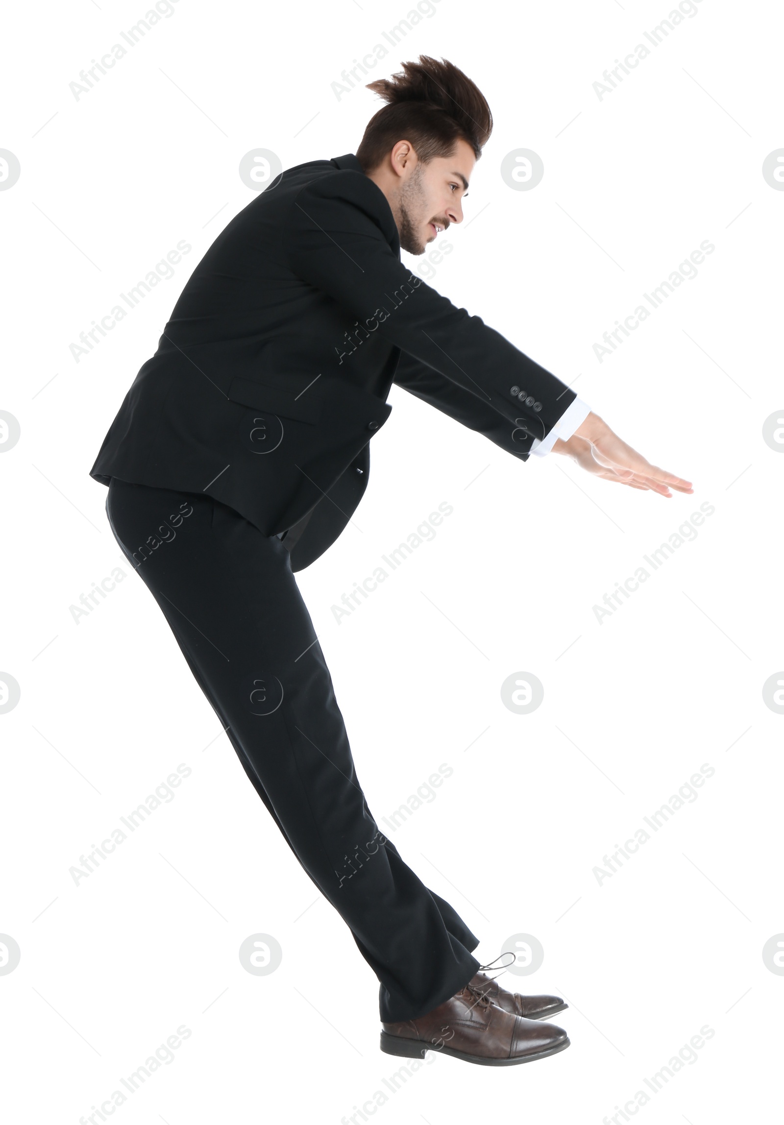 Photo of Young businessman attracted to magnet on white background