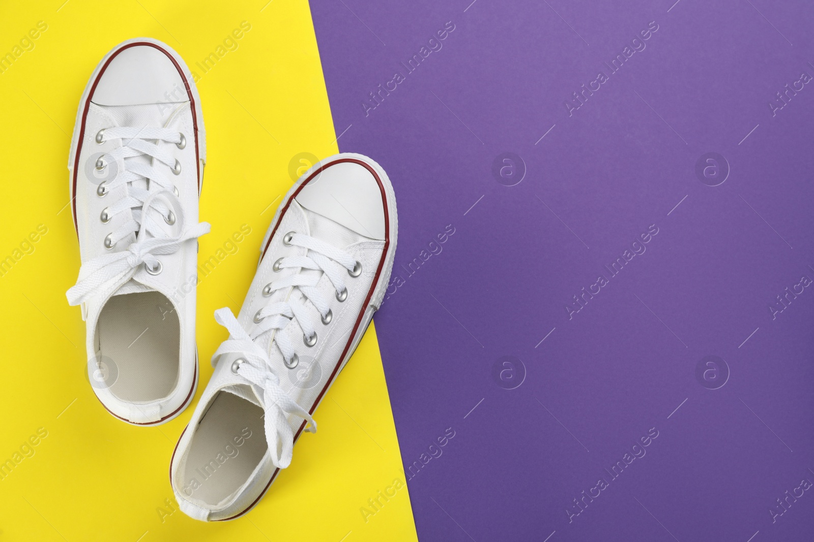 Photo of Stylish sneakers on color background, flat lay. Space for text