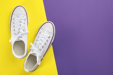 Photo of Stylish sneakers on color background, flat lay. Space for text