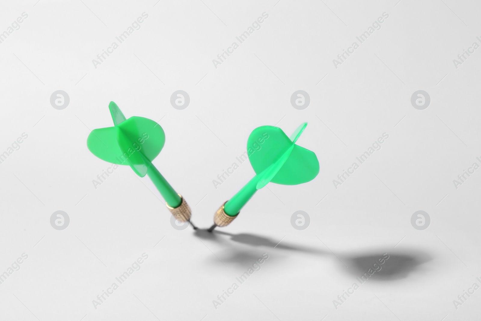 Photo of Green dart arrows for game on white background, above view