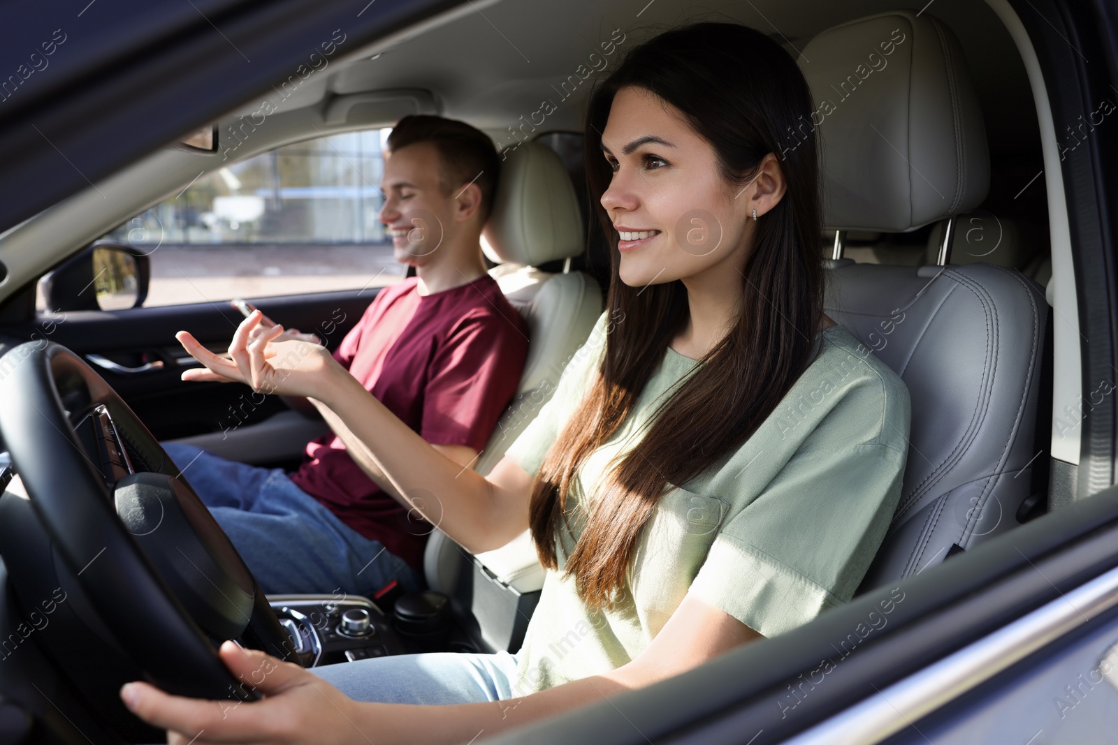 Photo of Happy young couple travelling together by car