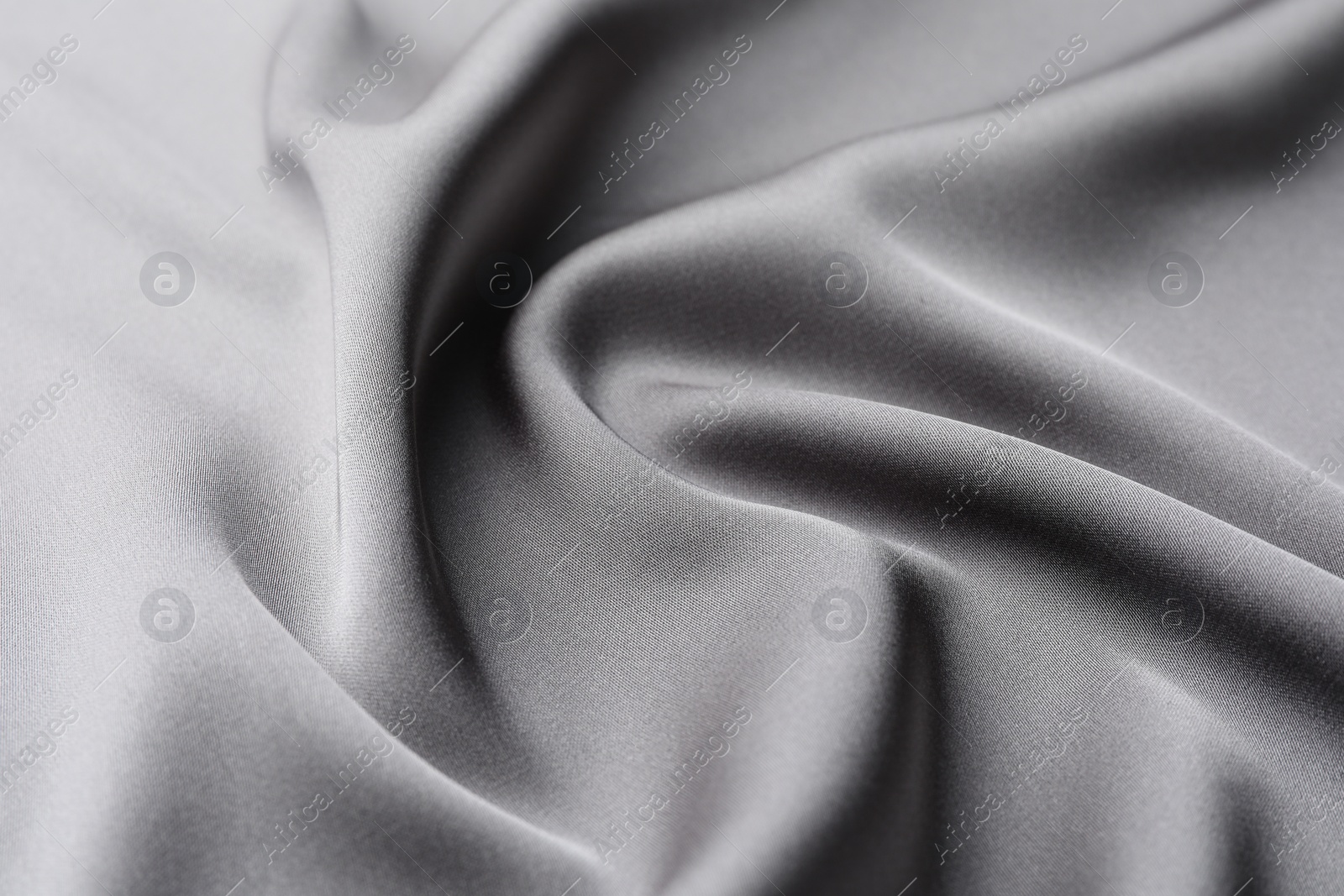 Photo of Texture of beautiful light grey silk fabric as background, closeup